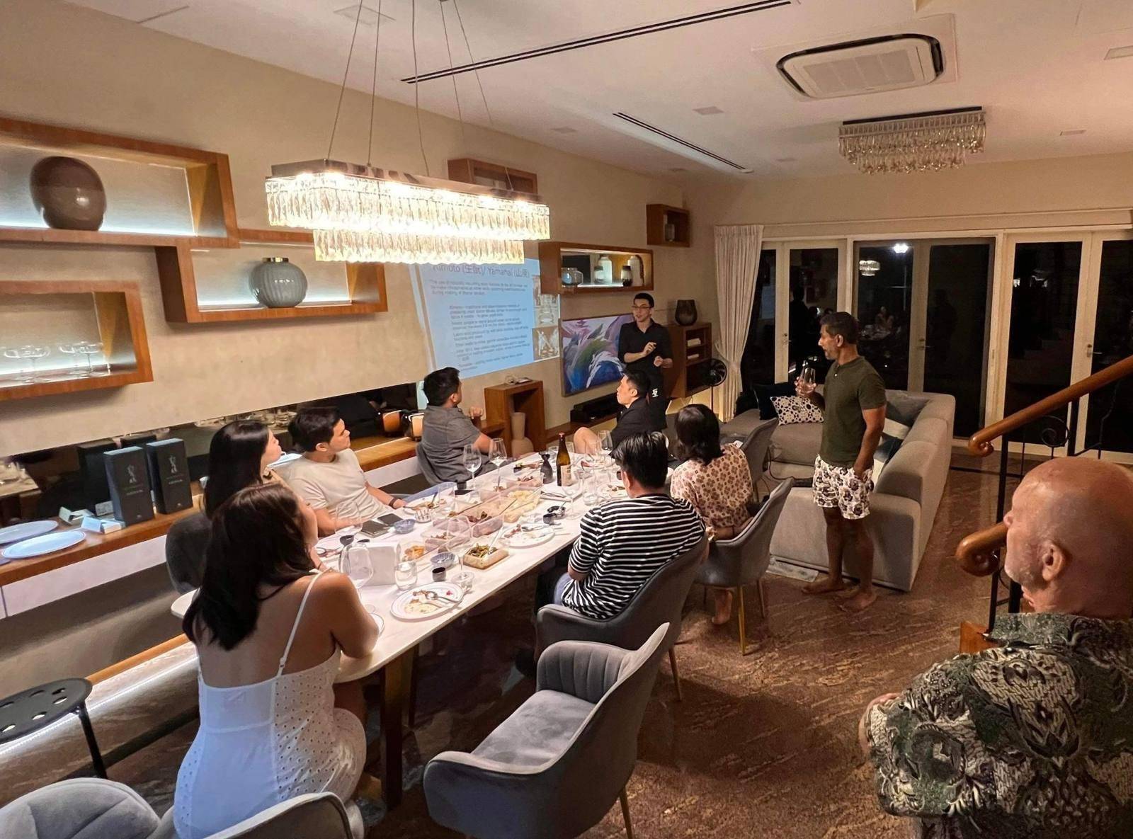 Guests at a long table sake tasting